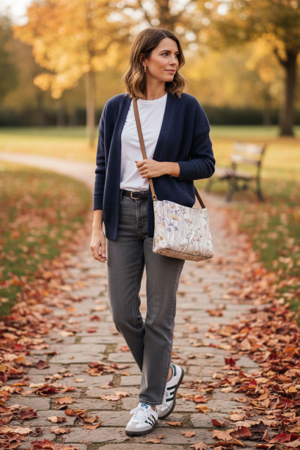 Mujer con vaqueros grises y cardigan azul marino en un look casual